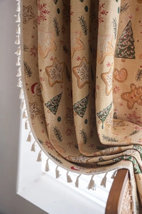 Close-up of Christmas gingerbread man jacquard fabric with tassels and holiday patterns