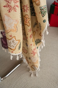 Close-up of Christmas gingerbread man and tree jacquard weaving with white tassels