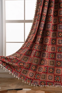 Detailed texture of red geometric jacquard curtain with elegant white tassel fringe