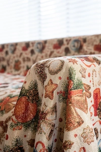 Close-up of thick jacquard fabric showing Christmas bell and berry weave patterns