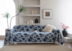 Close-up of blue floral jacquard texture and fine fringe edge on thick sofa cover