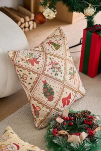 Dettaglio della federa natalizia in jacquard con motivi di alberi e fiocchi rossi