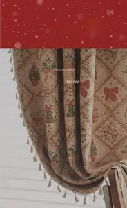 Detail of Christmas beige curtain with red bows, tree patterns and fringe edge trim