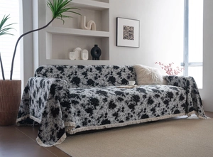 Gros plan sur tissu jacquard épais avec graffitis floraux noirs et finitions à franges