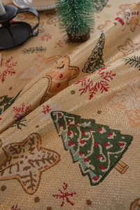 Detail of Christmas jacquard tablecloth with metallic threads and gingerbread man pattern