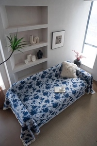 Detailed texture of blue jacquard sofa cover with fringe edges and thick woven fabric