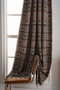 Close-up of bohemian geometric jacquard curtain with vintage patterns and fringe details
