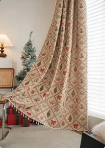 Detail of Christmas jacquard curtain with festive tree and bell patterns and white tassels