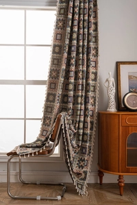 Detail of retro geometric jacquard pattern fabric with elegant beige tassels fringe
