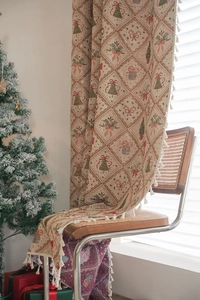Close-up of beige knitted Christmas jacquard fabric with tassels on a wooden chair