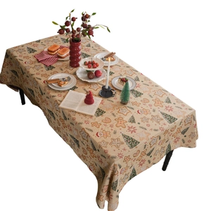 Christmas tablecloth with gingerbread man and tree patterns on woven fabric