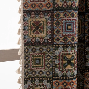 Bohemian geometric jacquard curtain with tassels in navy blue, red, and yellow colors