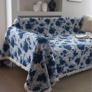 French style blue floral jacquard sofa cover blanket with tassels in minimalist home setting