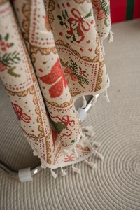Detail of Christmas jacquard fabric with festive patterns and decorative white fringes