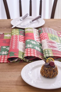 Close-up of woven Christmas table runner featuring reindeer, snowflake and plaid patterns