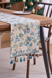 Detail of Nordic jacquard table runner with vintage floral pattern and blue tassels