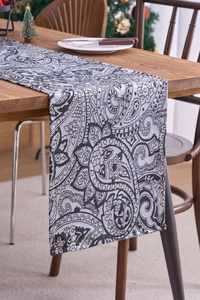 Close-up of vintage black and white paisley table runner with intricate floral patterns