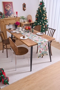 Close-up of tropical jacquard table runner with leaf patterns and elegant tassel detail