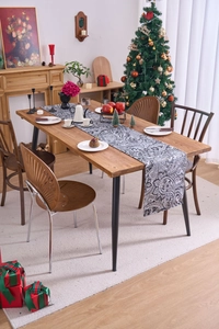 Detailed view of paisley table runner on Christmas dining table with festive decor