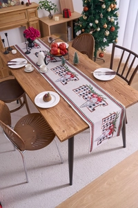Detail of Christmas gnome table runner with Believe text and red green woven edges