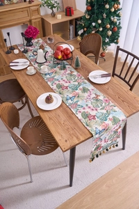 Detailed close-up of Nordic jacquard table runner with tropical floral print and tassels