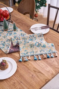 Detailed close-up of Nordic jacquard table runner with blue floral patterns and tassels