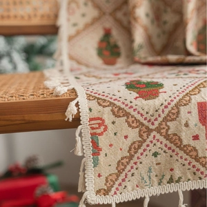 Christmas jacquard table runner with festive tree patterns and tassel edge details