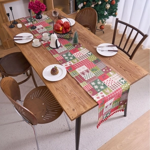 Christmas table runner with deer and snowflake patterns and red pompom trim decoration