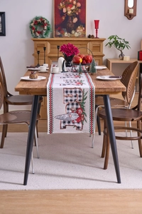 Close-up of Nordic Christmas gnome and plaid lettering on a textured cotton table runner