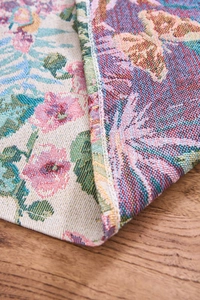 Detailed jacquard fabric showing vintage floral pattern, textures, and reinforced edges