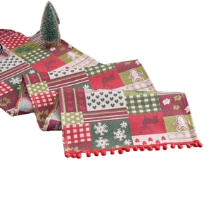 Christmas table runner with reindeer and snowflake jacquard patterns and red pom-poms
