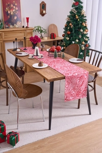 Detail of red and white paisley Christmas table runner with festive holiday decor