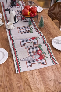 Detail showing Christmas gnome table runner with plaid pattern on a wooden dining table