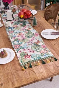 Detail showing vintage floral jacquard table runner with green lace and tassel trim