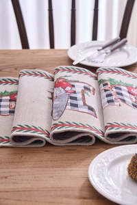 Close-up of jacquard Christmas table runner with Santa Claus and buffalo plaid pattern