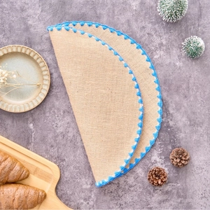 French country style jute round placemats with bright blue crochet lace edges for dining