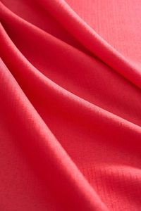Close-up of festive red festive tablecloth showing durable linen texture and fabric weave