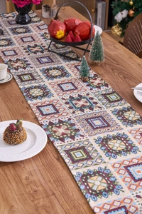 Detail of bohemian jacquard table runner with geometric patterns on a wooden dining table