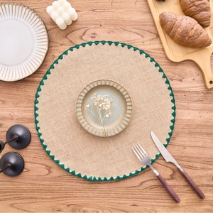 French country round jute placemat with green crochet lace on wooden table set