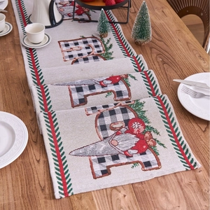 Christmas table runner with JOY gnome design and buffalo plaid accents on wooden table