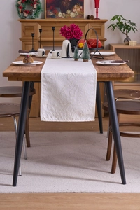 Detail of cream damascus jacquard table runner showing intricate 3D floral texture fabric