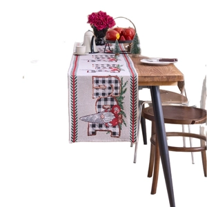 Christmas table runner featuring festive Gnomes and black white plaid patterns on white