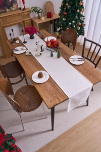 Detailed close-up of white Damascus jacquard table runner on a festive wooden table