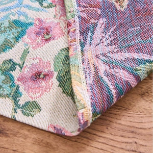 Nordic red jacquard table runner with floral patterns on a wooden surface