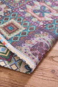 Close-up of geometric jacquard Christmas table runner showing colorful woven fabric texture