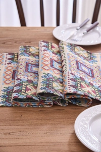 Close-up of jacquard woven table runner with geometric patterns and fringe detail