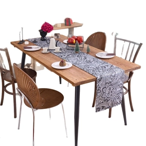 American style Christmas table runner with black and white paisley jacquard on a wooden table
