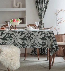Close-up of vintage dark green floral tablecloth with tropical leaf patterns