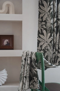 Detailed texture of jacquard chenille curtain featuring green palm leaf plant pattern