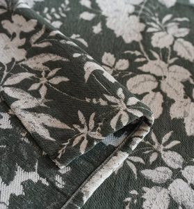 Vue détaillée du tissu jacquard vert épais avec une texture tissée haut de gamme